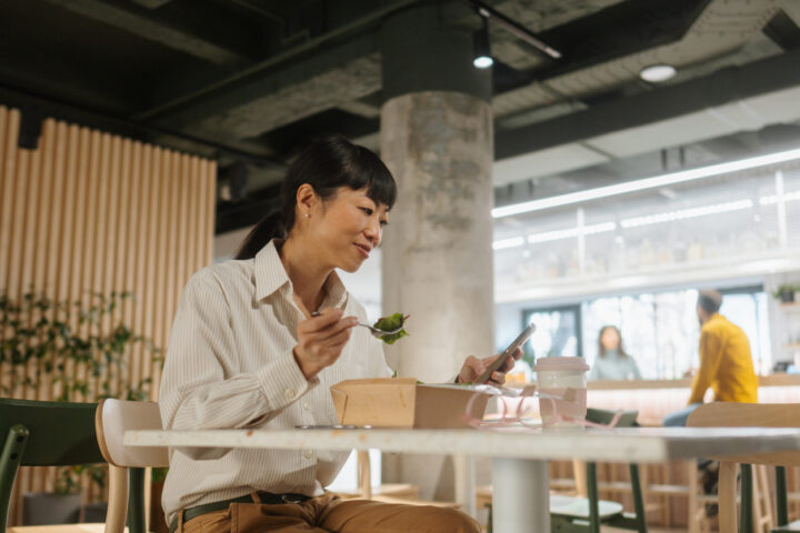 Woman having a lunch break in the office cafeteria